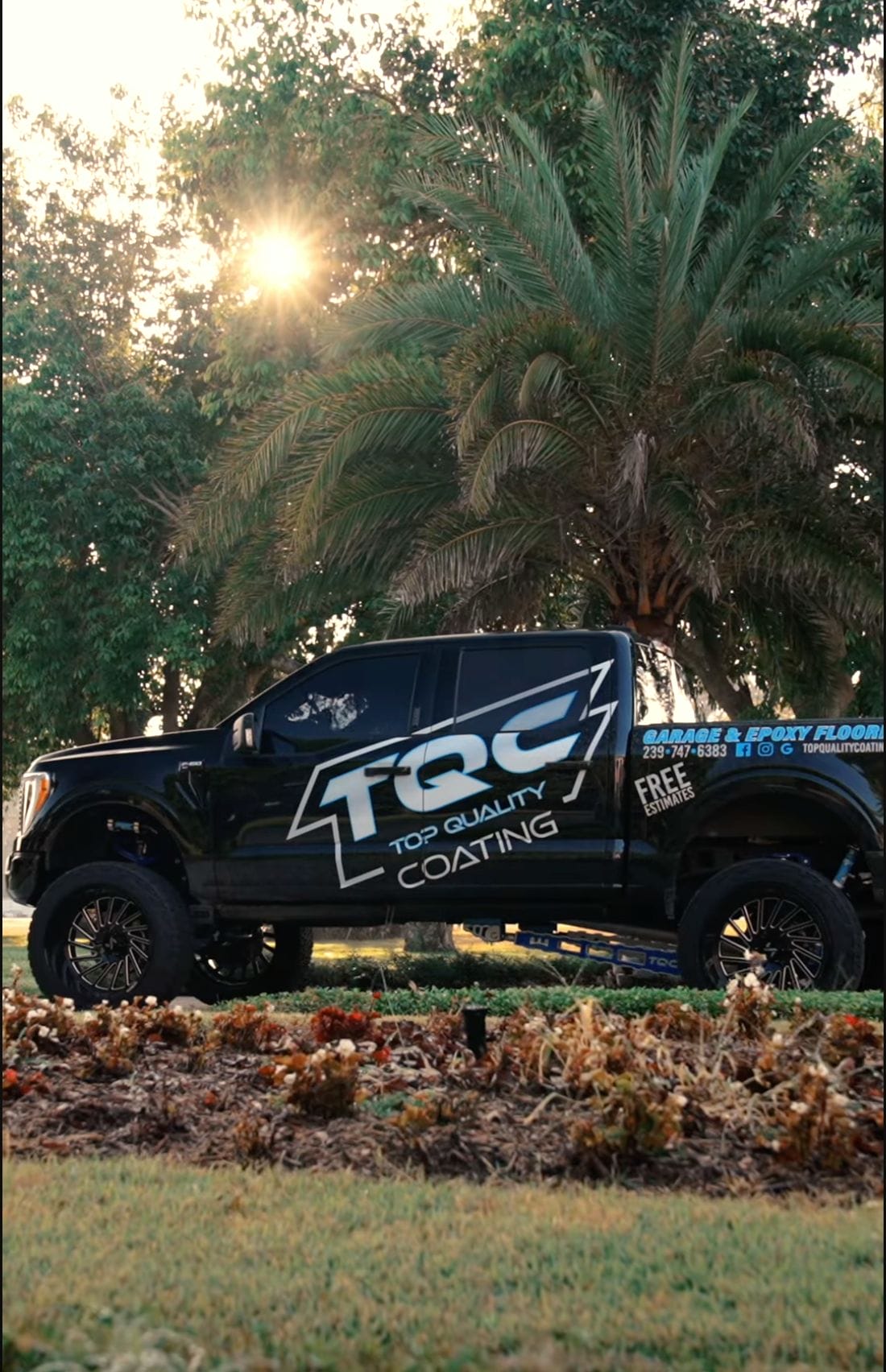 Top Quality Coating service truck parked in Naples, FL, ready for an epoxy floor installation.